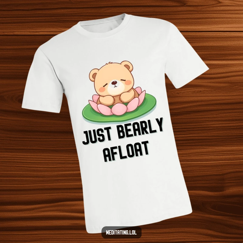 Funny bear cub t-shirt featuring a round, peaceful bear cub napping on a lily pad, embodying ultimate relaxation.
